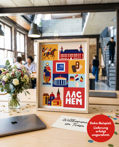 Gerahmtes Aachen Poster auf Büroschreibtisch als Mitarbeitergeschenk für Onboarding mit rotem Hinweis Lieferung erfolgt ungerahmt.